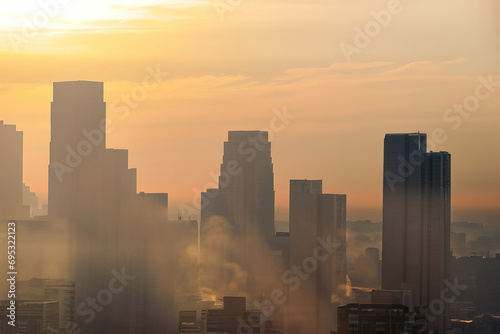 smoke in the sky, pollution on the city, sunset with skyscrapers