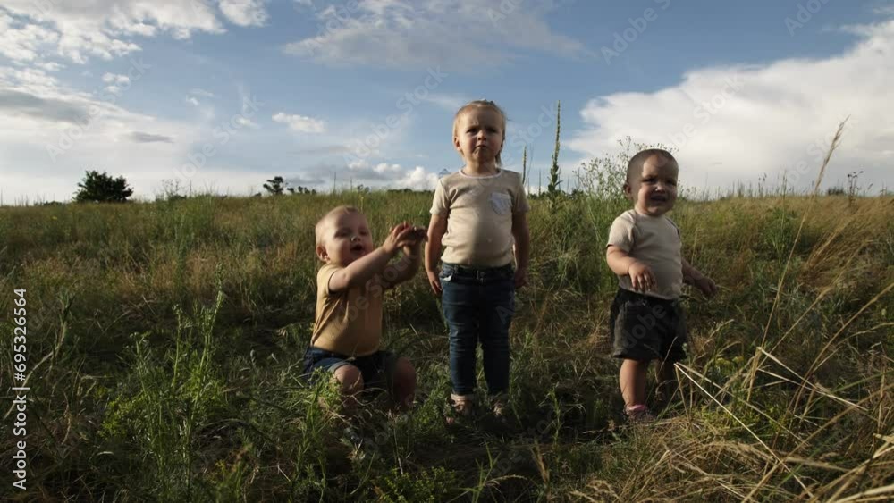 Out Ina Field Happy children playing in a field outdoors. Children's games and ...