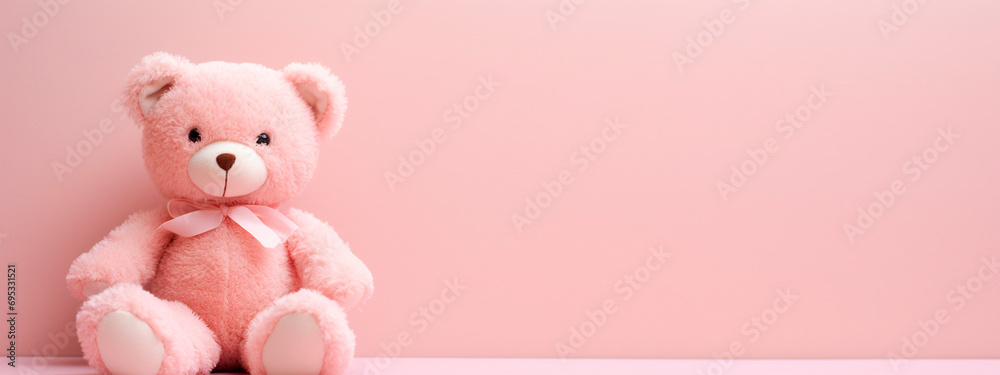 Obraz premium Pink teddy bear on a pink background. Selective focus.