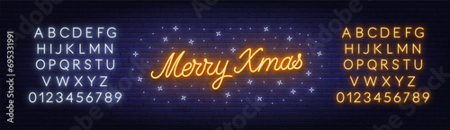 Merry Xmas neon lettering on brick wall background.  White and Yellow neon alphabets.