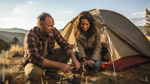 Mature Hispanic couple setting up tent for camping in the wilderness