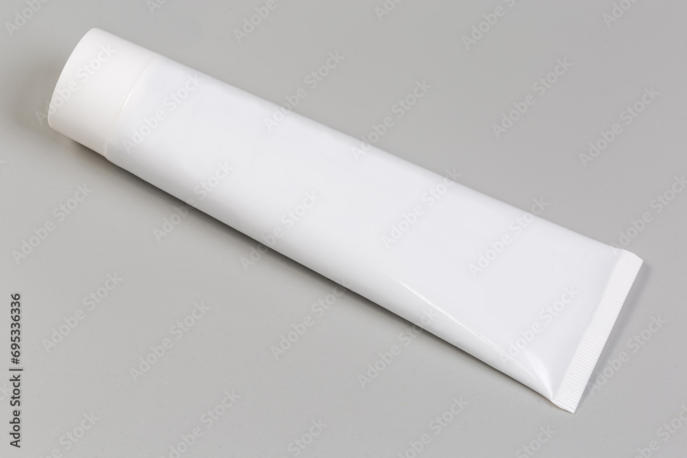 White plastic tube of toothpaste or other hygiene care product White plastic tube of toothpaste or other hygiene care product