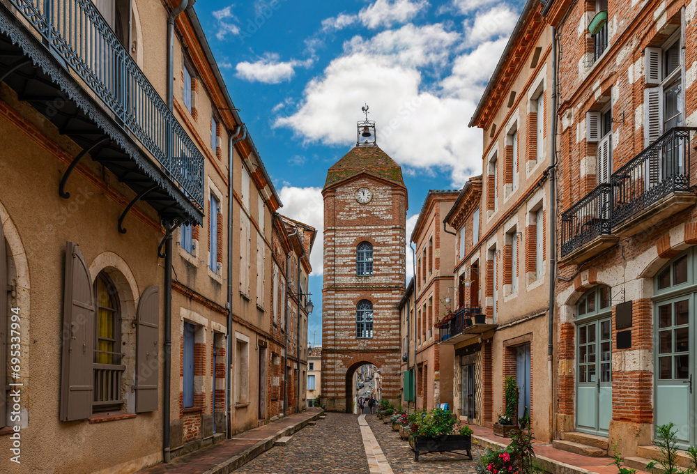 Medieval village of Auvillar and its clock tower, in Tarn et Garonne, Occitanie, France - obrazy, fototapety, plakaty 