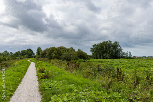 Cycling and hiking road along lake Schildmeer between Schildwolde en Overschild in municipallity MIidden-Groningen Groningen province in The Netherlands photo