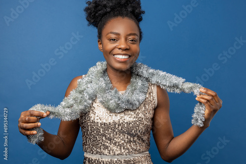 Smiling woman in golden dress and with a necklet looking enjoyed