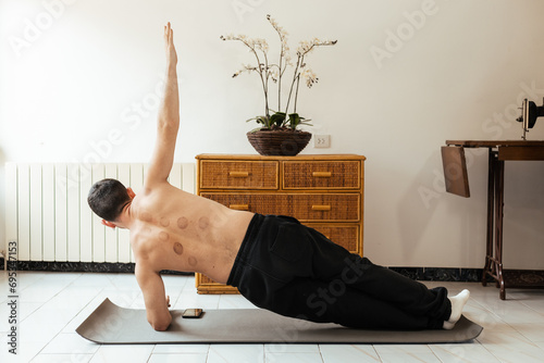 Man doing rehab exercise on mat at home