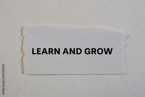 Learn and grow lettering on ripped paper. Conceptual photo.