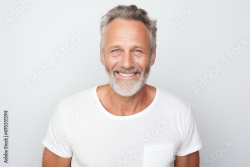 Portrait of a grinning man in his 50s donning a trendy cropped top against a white background. AI Generation