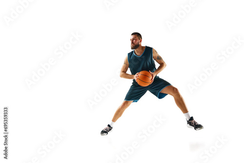 Full length portrait of athletic man, professional basketball player actively training before match against white background. © Lustre