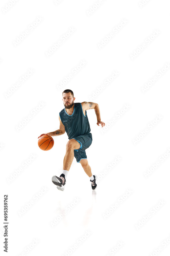 Powerful moment frozen in time, basketball player commitment to perfect slam dunk against white background.