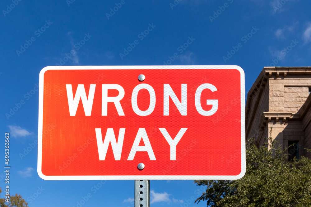 warning sign wrong way on red background warning sign wrong way on red background