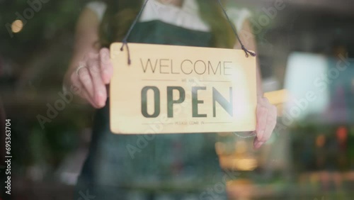 Woman entrepreneur with Open sign in cafe shop , small business concept