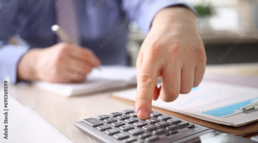 Fototapeta premium Businessman Calculate Finance Budget Press Button. Male Accountant Manager Making Annual Calculation, Notes at Workplace. Statistic Audit, Business Bookkeeping, Office Accounting Concept