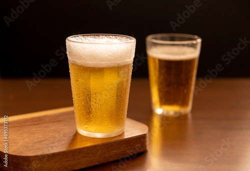 American glass with Beer on wooden table (Traditional Brazilian Cup)