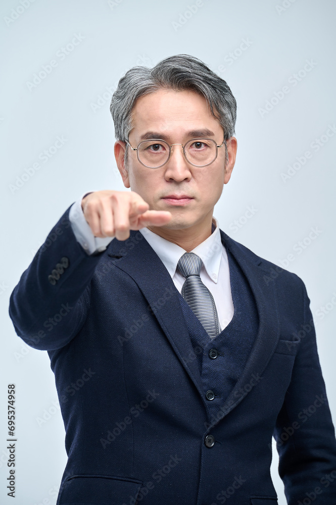 A middle-aged man in a suit expresses various emotions through facial expressions and hand gestures. A middle-aged man in a suit expresses various emotions through facial expressions and hand gestures.