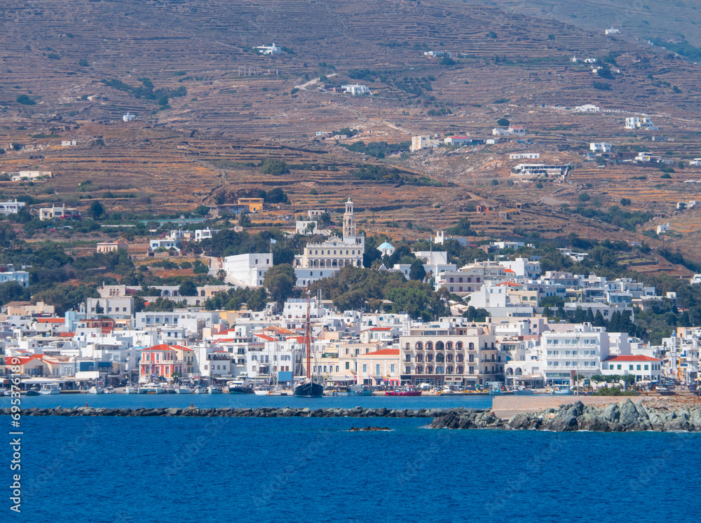 Panoramic view of the capital of the island of Tinos, the Church of the Annunciation and the trail of the ferry from the Aegean Sea