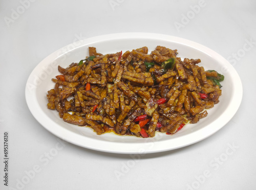 Tempe oreg is traditional food from indonesia made of tempeh which is cut into small pieces and then cooked with spices and chilies photo
