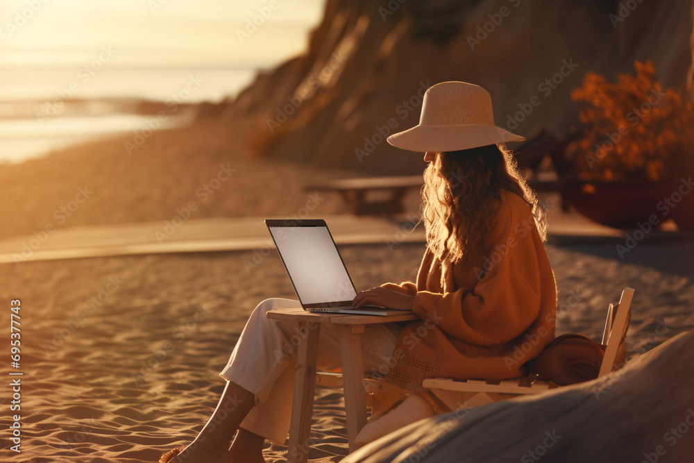 Woman at the beach using a laptop