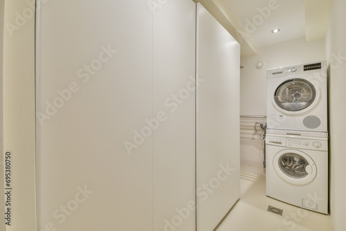 Modern Stacked Washer and Dryer in Laundry Closet photo