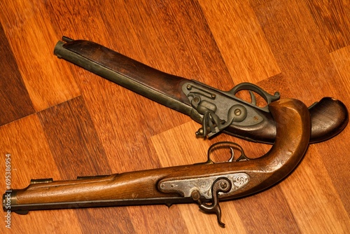 Vintage Firepower: Antique Gun on Weathered Wood Background