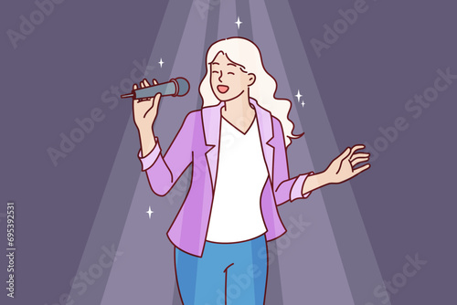 Woman sings karaoke holding microphone and enjoying creative hobby during party in nightclub. Girl visits karaoke bar and sings favorite songs standing in spotlight and dreaming of becoming celebrity.