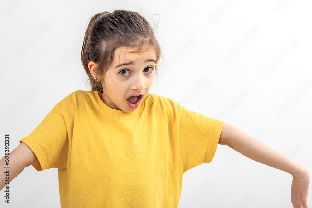 Surprised little girl throws up her hands, isolated on a white. Surprised little girl throws up her hands, isolated on a white.