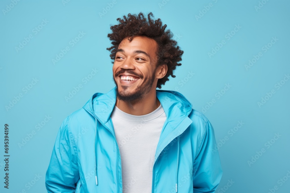 Portrait of a cheerful afro-american man in his 30s wearing a functional windbreaker against a soft blue background. AI Generation Portrait of a cheerful afro-american man in his 30s wearing a functional windbreaker against a soft blue background. AI Generation
