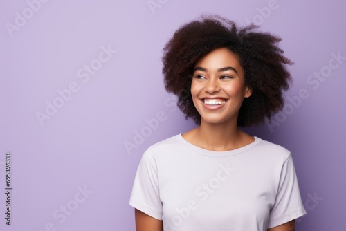 Portrait of a joyful afro-american woman in her 20s wearing a simple cotton shirt against a soft purple background. AI Generation