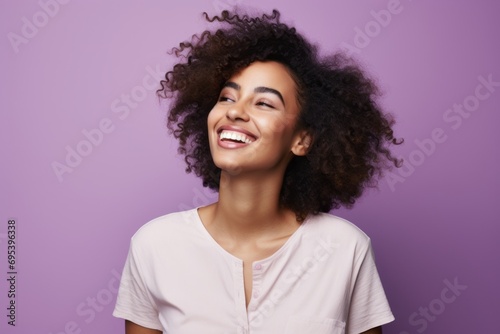 Portrait of a joyful afro-american woman in her 20s wearing a simple cotton shirt against a soft purple background. AI Generation