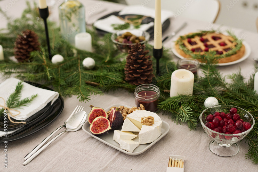 Closeup of treats put on festive table decorated with christmas tree branches Closeup of treats put on festive table decorated with christmas tree branches