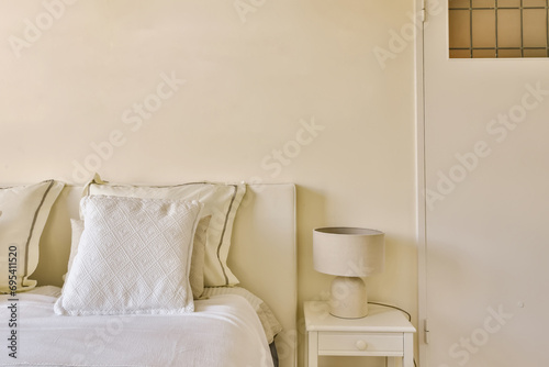 Bedroom with white bed and lamp photo