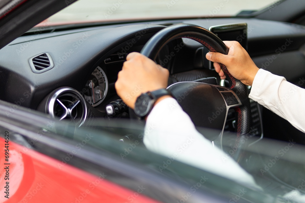 Arms of unrecognizable man driving car Arms of unrecognizable man driving car