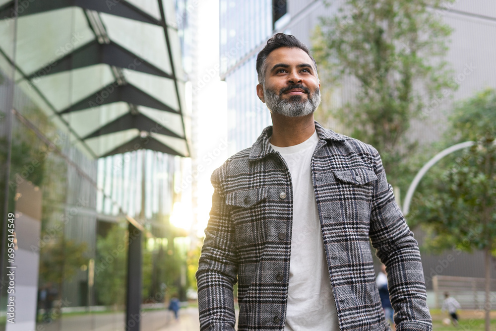 custom made wallpaper toronto digitalSmiling Indian businessman in casual outfit walking along street