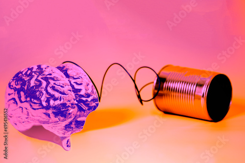 tin can phone with human brain anatomical model. communication concept photo