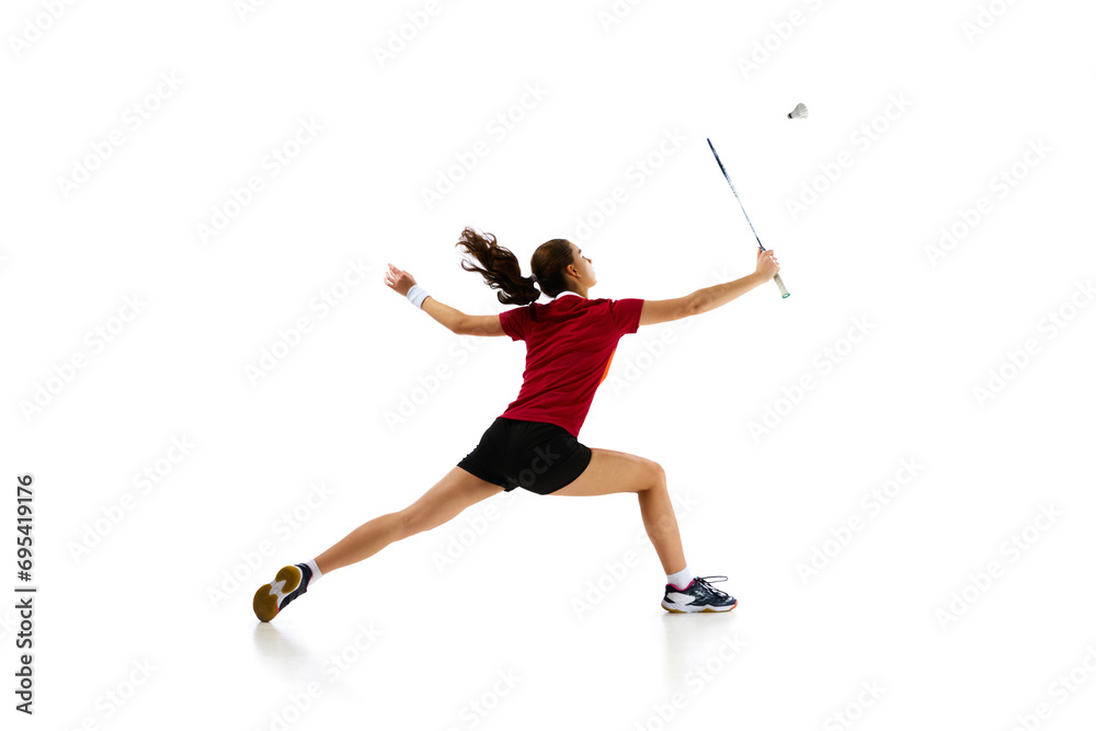 Badminton female athlete in motion, displaying attack and defense skills with finesse against white studio background. Concept of sport, active lifestyle, strength and power, action. Copy space. Badminton female athlete in motion, displaying attack and defense skills with finesse against white studio background. Concept of sport, active lifestyle, strength and power, action. Copy space.