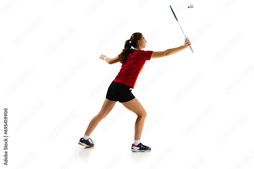 Skilled female badminton player in action, demonstrating attack and defense techniques with finesse against white background. Concept of sport, active lifestyle, strength and power, action. Copy space Skilled female badminton player in action, demonstrating attack and defense techniques with finesse against white background. Concept of sport, active lifestyle, strength and power, action. Copy space