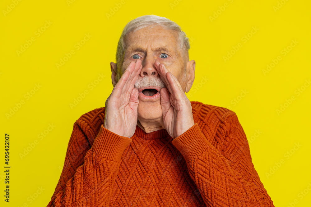 Keep my secrets, silence. Senior old man whisper news rumors holding hands near mouth, share gossip, quiet. Elderly grandfather pensioner telling interesting confidential story on yellow background Keep my secrets, silence. Senior old man whisper news rumors holding hands near mouth, share gossip, quiet. Elderly grandfather pensioner telling interesting confidential story on yellow background