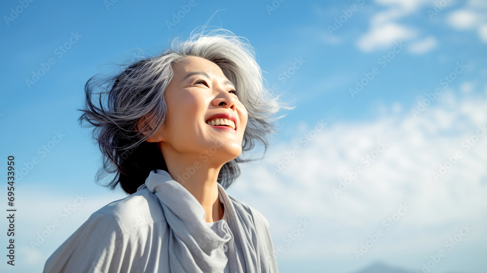 Happy Elderly Japanese Woman with Gray Hair Looks Into the Blue Sky Happy Elderly Japanese Woman with Gray Hair Looks Into the Blue Sky