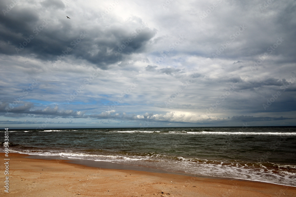 A deserted beach is patiently waiting for the storm to arrive. A deserted beach is patiently waiting for the storm to arrive.