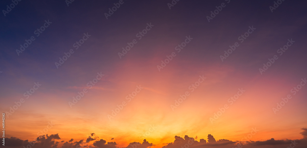 Obraz premium Morning sunrise sky with sunset colorful orange sun rays and dark clouds 