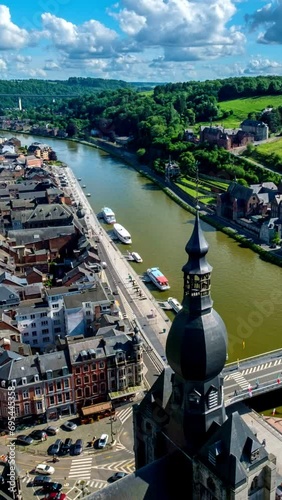 Timelapse of aerial view Dinant town, Collegiate Church of Notre Dame de Dinant, River Meuse and Pont Charles de Gaulle bridge from Dinant Citadel. Belgium. Camera pan effect photo