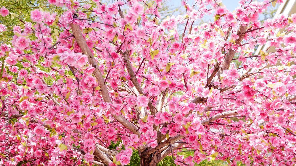 Decoration artificial plastic pink cherry blossoms (sakura)  for background.