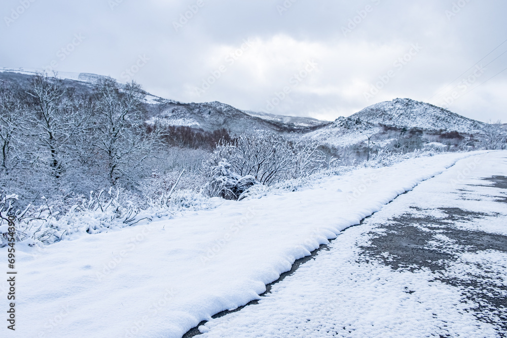 mountain road after a snowfall in Galicia, Spain
