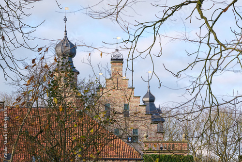 View of the Poptaslot in Marsum Friesland The Netherlands in winter with bare trees. Poptaslot also called Azingastate or Heringastate is a stins which was founded in the 15th century. photo