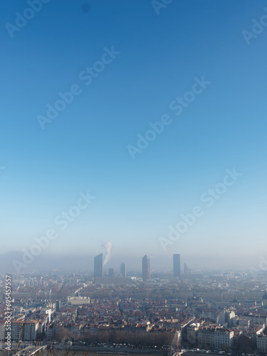 View of Lyon from Fourviere hill on a winter day, foggy polluted city and blue sky