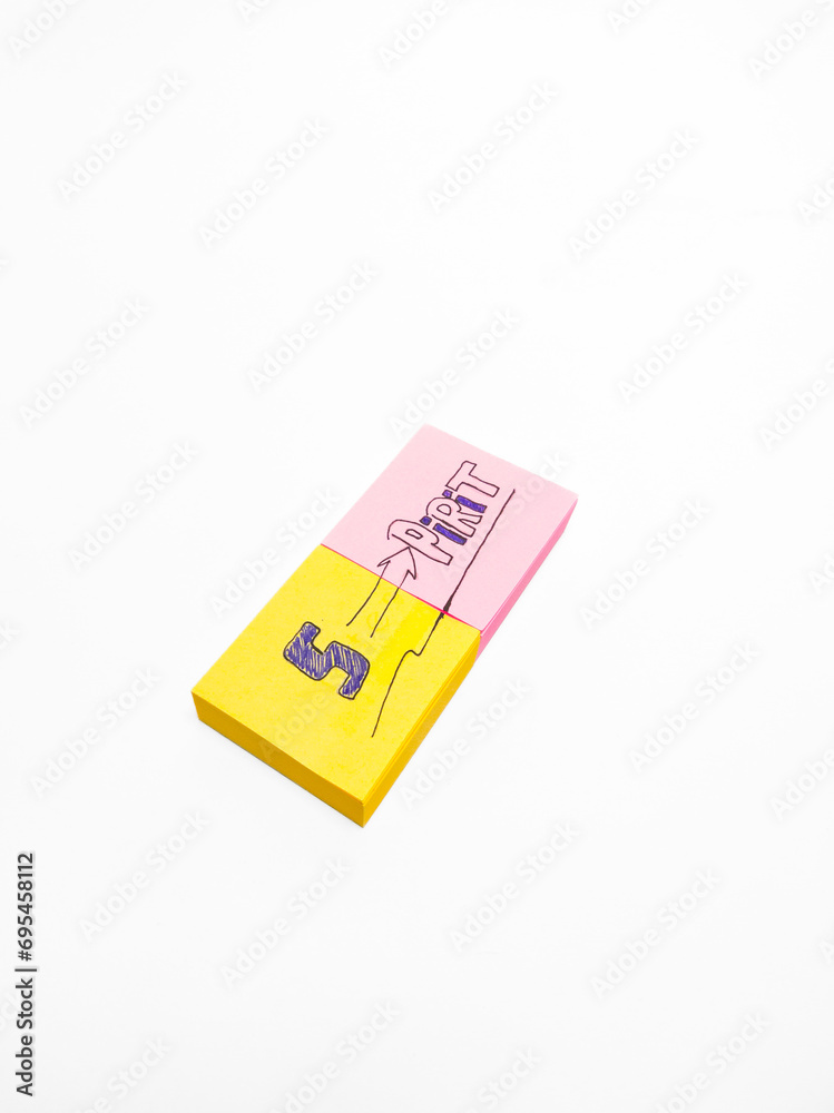handwritten with the word Spirit written on a small yellow and pink note useful for self-encouragement and self-development, on a white background