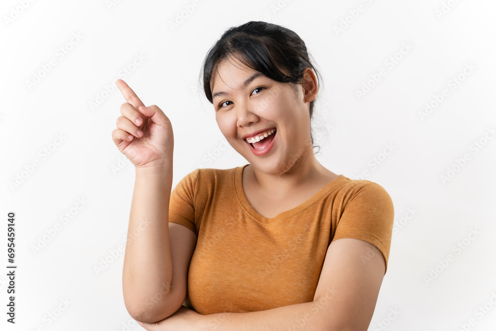 The cheerful young Asian woman has great thought, finding inspiration or solutions to solve a problem. pointing finger up standing on white background. The cheerful young Asian woman has great thought, finding inspiration or solutions to solve a problem. pointing finger up standing on white background.