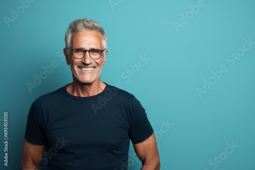 Portrait of a grinning man in his 60s donning a trendy cropped top against a plain cyclorama studio wall. AI Generation