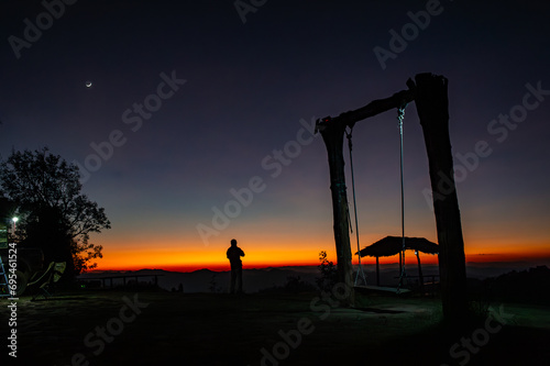 landscape view at civil twilight sunset with a crescent moon above