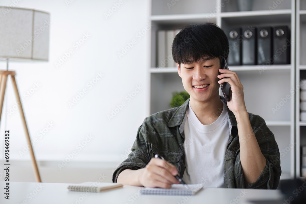 Young Asian man calling to discuss financial management Financial transactions and use of online banking